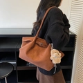 Brown suede tote bag with plush doll pendant accessory shown on a model - Brown with Pendant