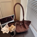 Brown suede tote bag with plush dog charm and long shoulder straps in a cozy office setting - Coffee with Pendant