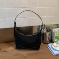 Detail of minimalist black hobo bag showing retro suede texture and leather stitching - Black