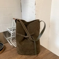 Detail of olive green suede bucket bag with decorative buckle and slim strap - Green