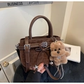 Brown leopard embossed leather handbag with crossbody strap and plush puppy charm - Coffee with Pendant