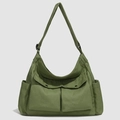 Army green oxford tote bag detail featuring front flap pockets and durable textured fabric - Green