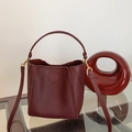 Detail of burgundy bucket bag with lychee pattern leather and gold metal hardware - Dark Wine Red