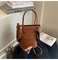 Detail of caramel PU leather bucket bag with beaded tassel charm and stitch detail - Dark Brown