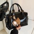 Chic black polished leather Boston bag with vintage baseball charms and gold hardware - With Charm Style / Black with Pendant