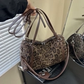 Chic leopard print barrel handbag with brown leather handles and silver metal hardware - Leopard Coffee