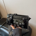 Black glossy patent leather crossbody bag with punk metal eyelets and adjustable strap - Black