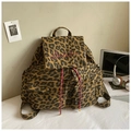 Close-up of leopard print canvas backpack with red script embroidery and drawstring detail - Brown