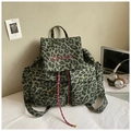 Detailed close-up of leopard print canvas backpack with red embroidery and drawstrings - Green