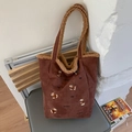 Detalle del bolso tipo cubo de pana con bordado de perrito y ribete de borreguito - Escote de un hombro / Marrón