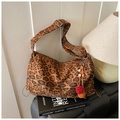Leopard print tote bag detail showing wide strap and decorative pompom keychain charm - Leopard Brown