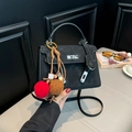 Black retro Kelly-style handbag with matte texture and colorful beaded fur ball pendant - Black with Pendant