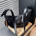 Minimalist black glossy leather hobo bag with a beaded charm on a shoulder strap - Black with Pendant