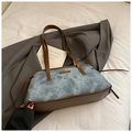 Blue denim tote bag with brown leather straps and side fringe tassels on a white bed - No Pendant / Denim Blue