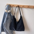 Large black frosted hobo tote bag with a vintage washed texture hanging on a wooden hook - No Pendant / Black