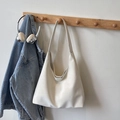 Minimalist white leather tote bag with wide shoulder strap hanging on a wall hook - No Pendant / Off White