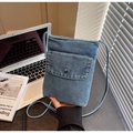 Detail of blue denim mini crossbody phone bag with snap closure and slim shoulder strap - Style 1 / Light Blue
