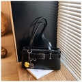 Close-up of black leather underarm bag with decorative belt buckle and plush charms - Black with Pendant