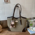 Dark leopard print tote bag with brown leather handles and plush bear charm accent - Dark Green Leopard With Pendant