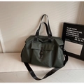 Detail of dark green waterproof travel bag with front buckle pocket and webbed handles - Green