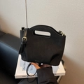 Minimalist black suede bucket bag with cut-out handle and adjustable shoulder strap - Black