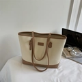 Minimalist beige and brown tote bag with leather texture shown in a lifestyle desk setting - No Pendant / Off White
