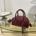 Vintage burgundy leather bowling bag with contrast stitching and adjustable strap - Ancorra Red