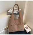 Detail of a brown canvas tote bag with 3D letter embroidery and side pockets - Khaki