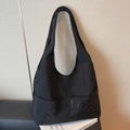 Chic black canvas tote bag with embossed lettering and large front pocket for daily commute - Black