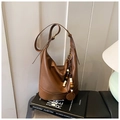 Detalle del bolso Hobo de cuero marrón con borla de cuentas de madera sobre un libro - Marrón con colgante
