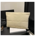 Quilted beige handbag and laptop sleeve with modern grid pattern in office setting - Khaki