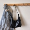 Minimalist black matte leather Hobo bag with tassel detail on a wooden hanger - Black without Pendant