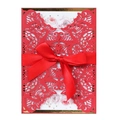 Macro shot of laser-cut red wedding invitation with floral insert and satin ribbon bow - Pearlescent Red