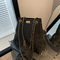 Retro black quilted bucket bag with long tassels and gold chain strap in matte finish - Black