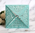 Detail of laser-cut rose hollow design on mint green wedding invitation with pearlescent finish - Tiffany Blue