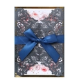 Detail showing the laser-cut lace design and blue satin ribbon on wedding invitation - Charcoal Black