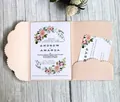 Elegant laser-cut floral wedding invitation set with pearl pink envelope on wood background - Nude Pink