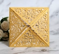 Macro detail of laser-cut gold rose pattern on luxury wedding invitation sleeve - Gold
