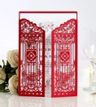 Detail of red laser-cut wedding invitation featuring intricate garden gate patterns - Pearl Red