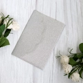 Silver glitter cardstock for elegant wedding invitations on a white wooden background - Silver