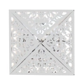 Detail of white laser-cut wedding invitation with intricate floral lace pattern - Silver
