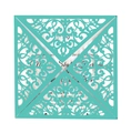 Detail of laser-cut turquoise invitation card featuring intricate floral vine patterns - Tiffany Blue