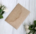 Macro view of gold glitter laser cut invitation card with textured shimmering finish - Rose Gold