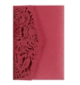 Macro detail of wine red laser-cut invitation card with elegant floral hollow patterns - Dark Red