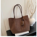 Detailed view of deep brown suede tote bag with wooden bead tassel and side stitching - Coffee with Pendant