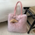 Pink plush tote bag featuring woven handles and a cute croissant charm in a cozy setting - Pink with Pendant
