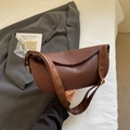 Brown woven shoulder bag with crescent shape and stylish wide strap in aesthetic setting - No Pendant / Coffee