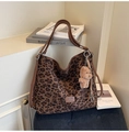 Detail of leopard print tote bag with brown leather straps and plush bear charm - Coffee with Pendant