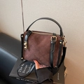 Brown quilted suede handbag with black leather accents and golden hardware detail - Coffee