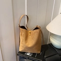 Minimalist brown suede bucket bag featuring a golden twist-lock and adjustable strap - Brown